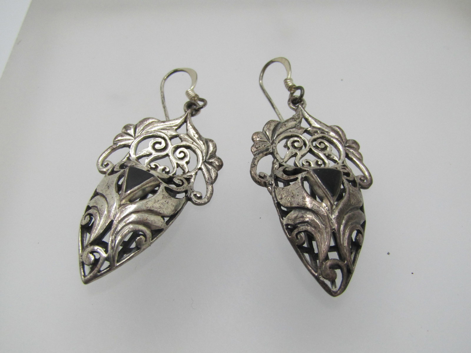 Vintage Sterling Onyx Scrolled Earrings, Pierced, 1980's-1990's: Vintage Sterling Onyx Scrolled Earrings, Pierced, 1980's-1990's. Very appeal scrolled design with a flat top that a triangular scrolled dome with a raised traingular bezel-set onyx The earrings are 2"