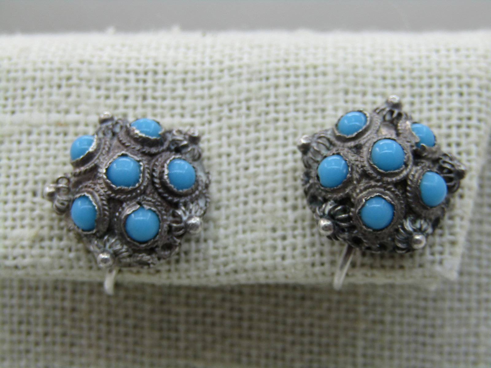 Vintage .835 Silver Turquoise Glass Earrings, Screw Back, Bali/Ethnic Themed: Vintage .835 Silver Turquoise Glass Earrings, Screw Back, Bali/Ethnic Themed. This has small 3.5mm round turquoise glass cabochons. There is a bend at one of the stones. The earrings are appx. 5/8" ro