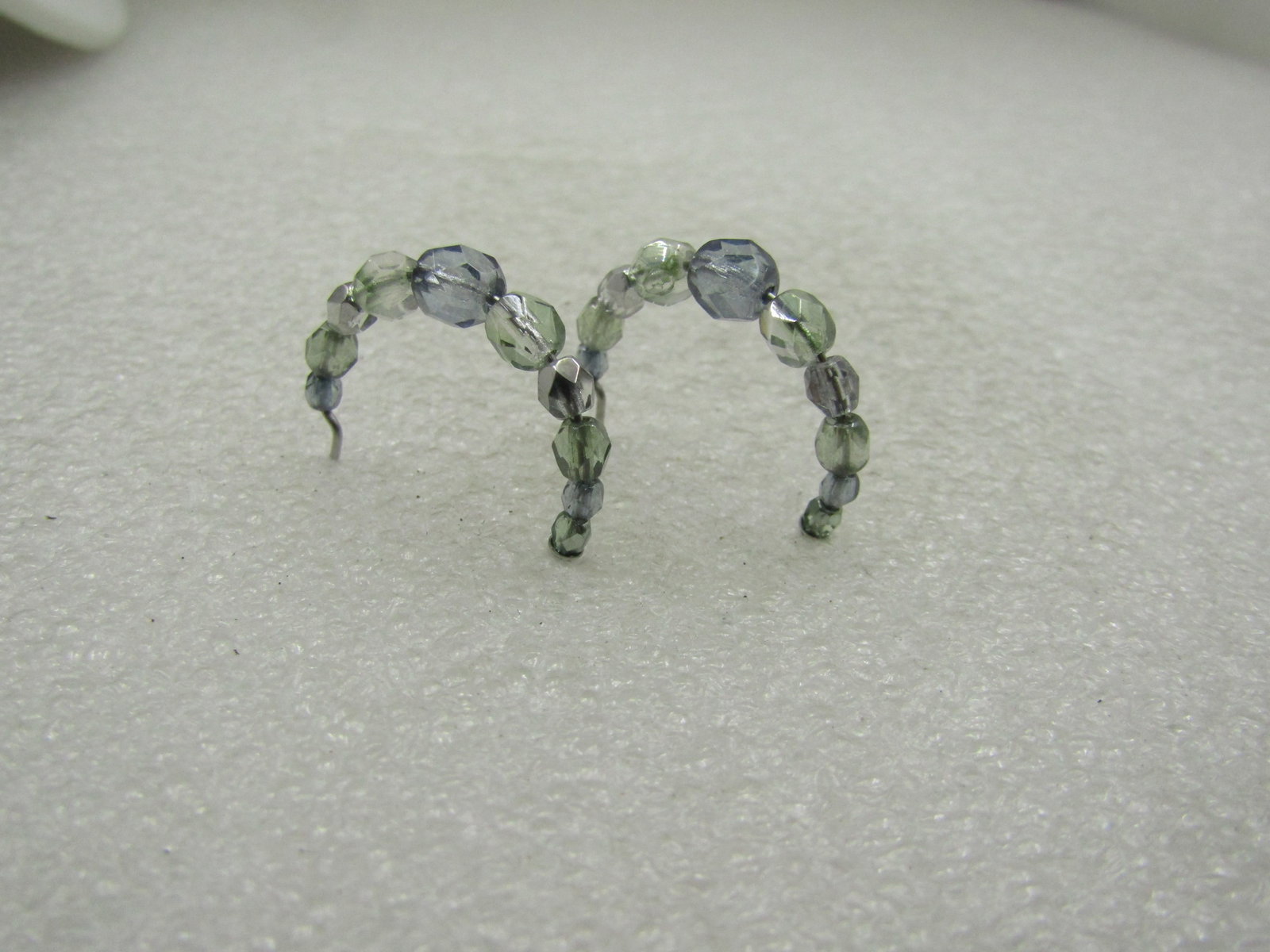 Vintage Liz Claiborne Beaded Hoop Earrings, 1", on Card: Vintage Liz Claiborne Beaded Hoop Earrings, Pierced, 1", on Card. Faceted graduated beads - crystal style beads with aurora borealis shimmer - the largest bead at center as a smoky blue hue and is 5mm