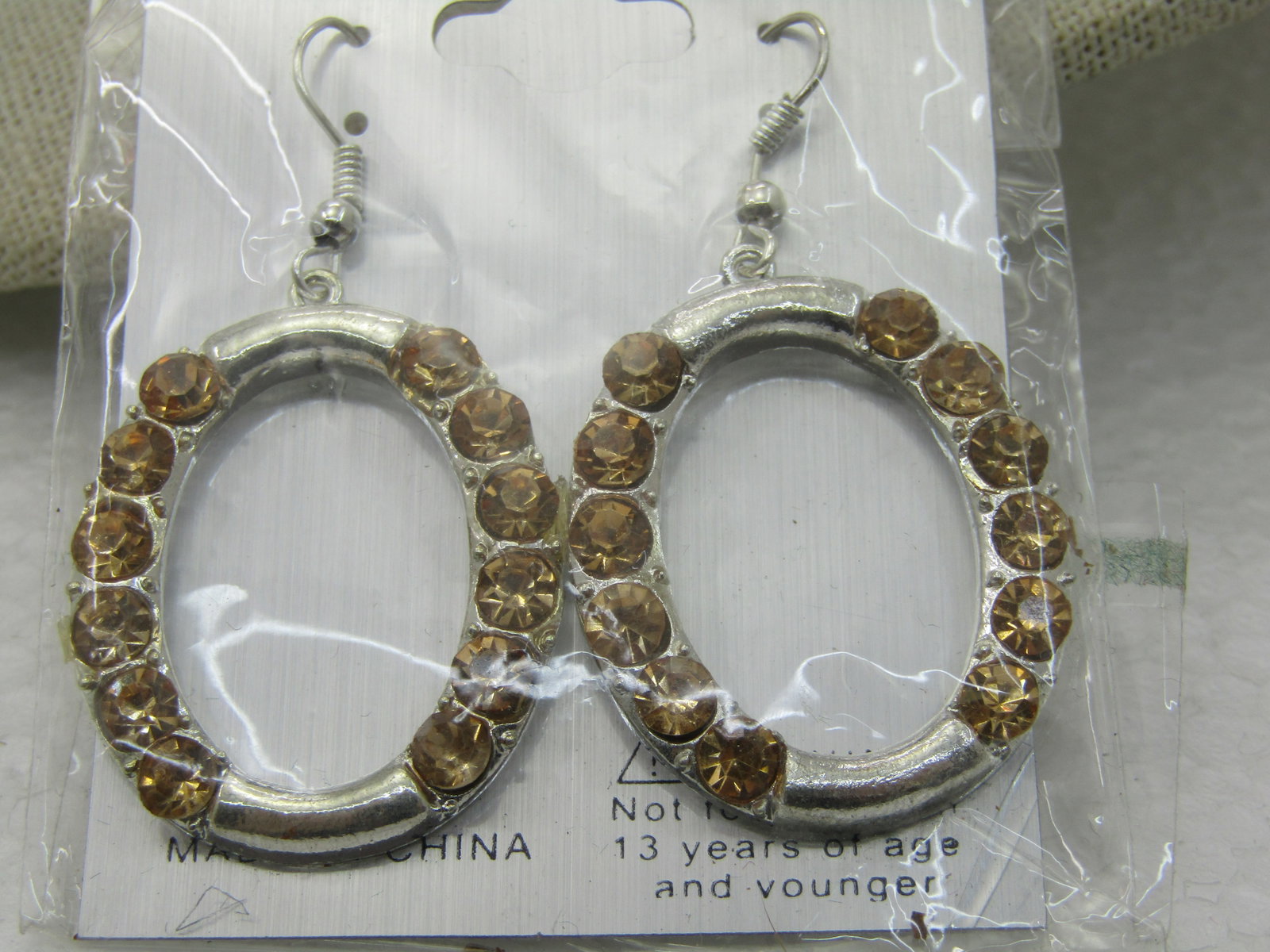 Silver Tone Golden Rhinestone Hoop Earrings, Pierced, New on Card, Crystal Collection: Silver Tone Golden Rhinestone Hoop Earrings, Pierced, New on Card, Crystal Collection, 2" long from curve in hook post and 1" wide. Silver tone oval hoops with golden crystal rhinestioneis on the