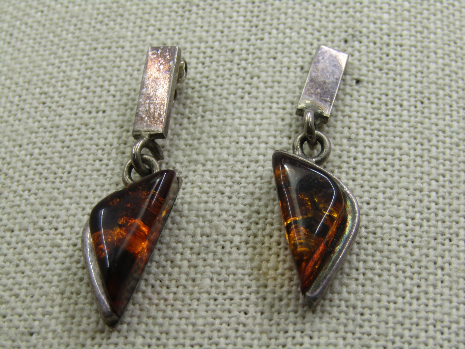 Vintage Sterling Amber Drop ModernistEarrings, 1.5",: Vintage Sterling Amber Drop Modernist Earrings, 1.5" long and slightly under 1/2" wide at the widest point. 1960's or slightly thereafter. A boder design with a bar stud from which a triangular sterli