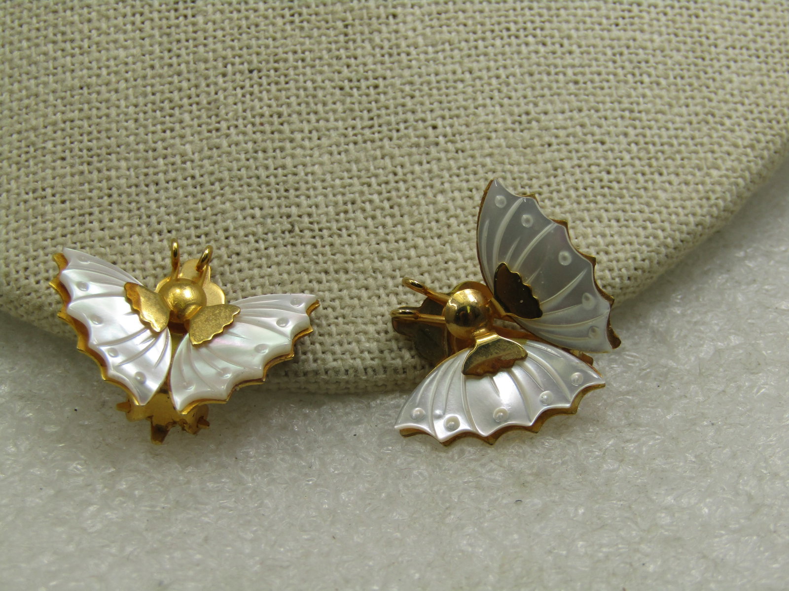 Vintage Mother-of-Pearl Butterfly Earrings, Clip, 1": Vintage Mother-of-Pearl Butterfly Earrings, Clip, 1" wide and appx. 7/8" tall with gold tone torso and wing accents. The mother-of-pearl has curved edges and carved details. Not signed by the maker.