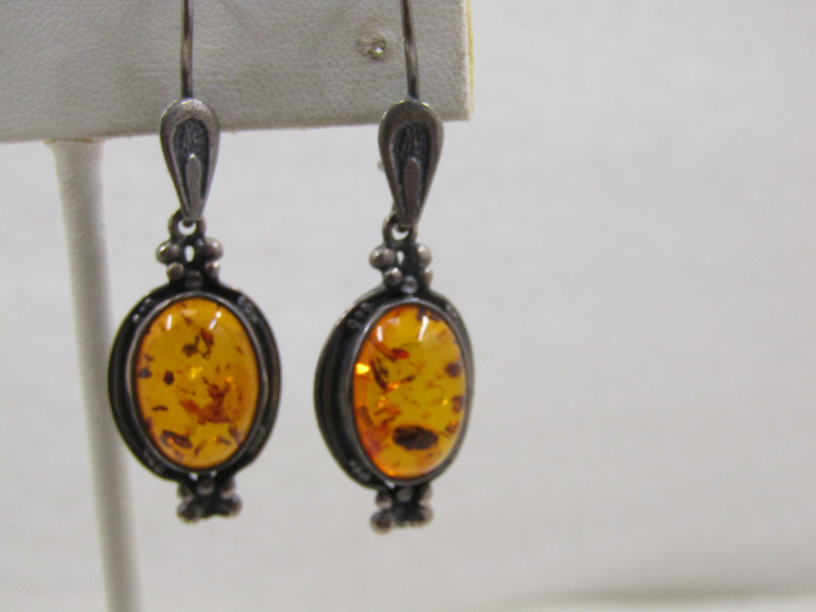 Vintage Sterling Amber Pierced Earrings, 1970's-1980's: . Vintage Sterling Amber Pierced Earrings, 1970's-1980's. 1.75" lock with locking hook post tear-drop accent on the hook, bezel-set appx. 13.5mm by 10mm amber cabochon with wider frame around the