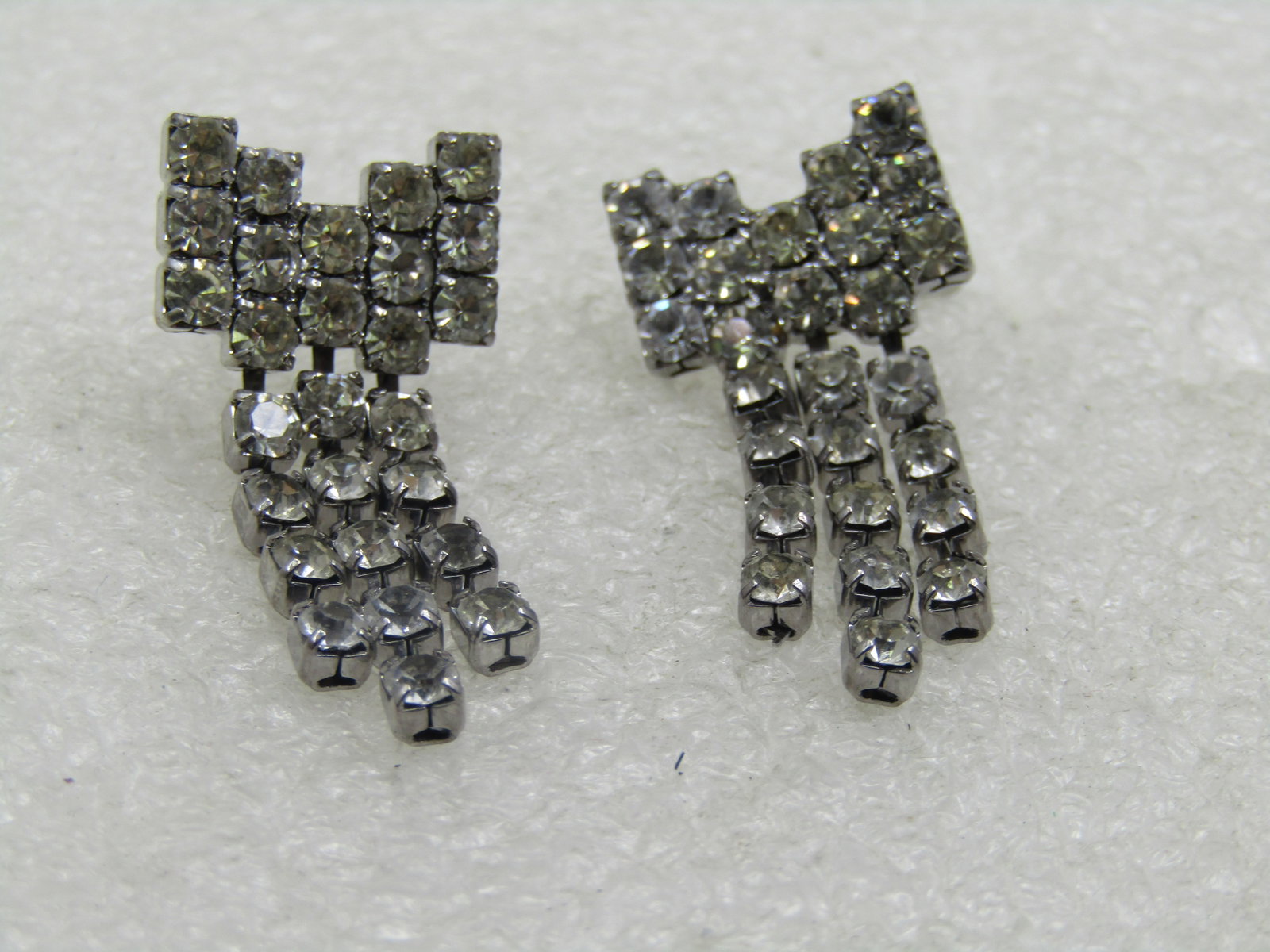 Vintage Rhinestone Bow Earrings, with Dangles, Pierced: Vintage Rhinestone Bow Earrings, with Dangles, Pierced. These are appx. 1.5" long and 5/8" wide with a tripe strand drop. All clear glass stones set in silver tone metal. Age is estimated at