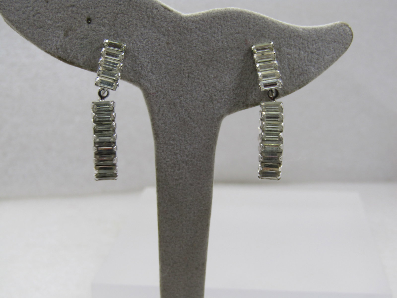 Vintage Rhinestone Baguette Clip Earrings, Stud & Drop Hoop, 1.25" long.: Vintage Rhinestone Baguette Clip earrings, Stud & Drop Hoop, 1.25" long. This has clear baguettes set on their sides as a stud bar that is appx. 5/8" long and a 3/4" long hoop with the same size bague