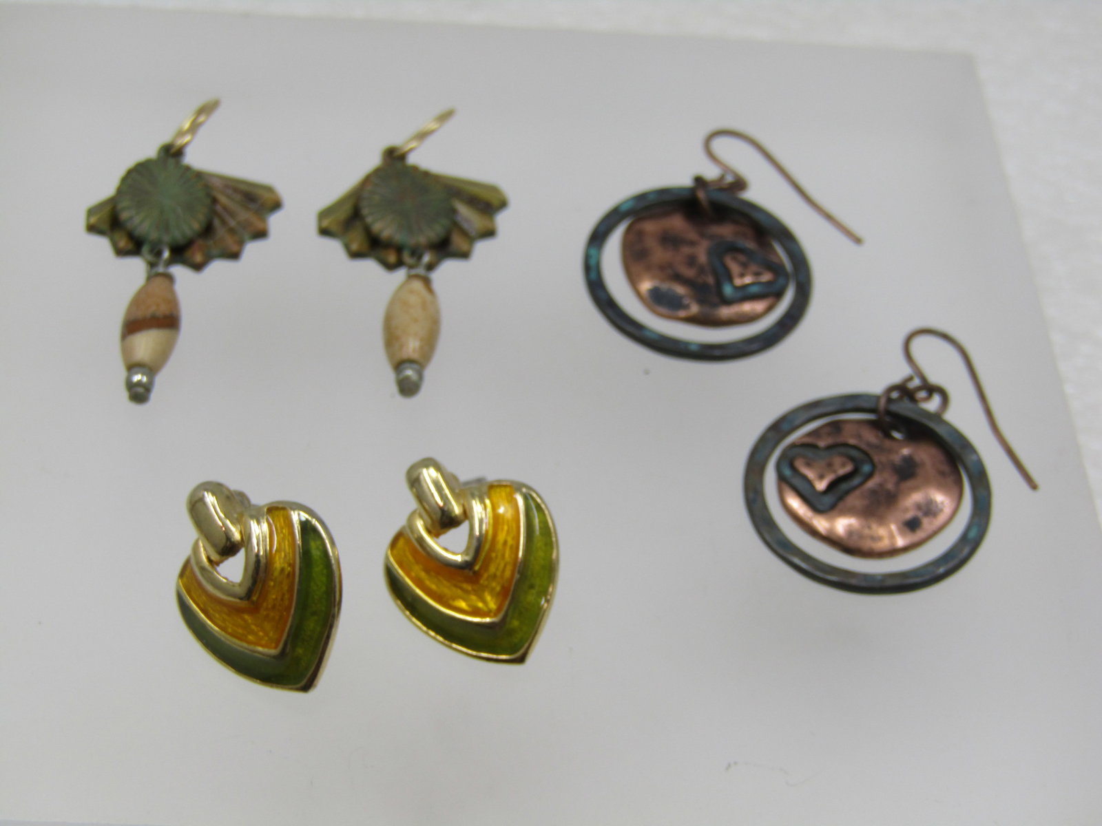 Vintage 3 Pairs Pierced Earrings, 1980's: Vintage 3 Pairs Pierced Earrings, 1980's. Copper done hammered dangles with heart accent and a hammered silver tone hoop with copper hook posts. 1.5" long from curve in post, Aoox, 3.4" wide. The seco