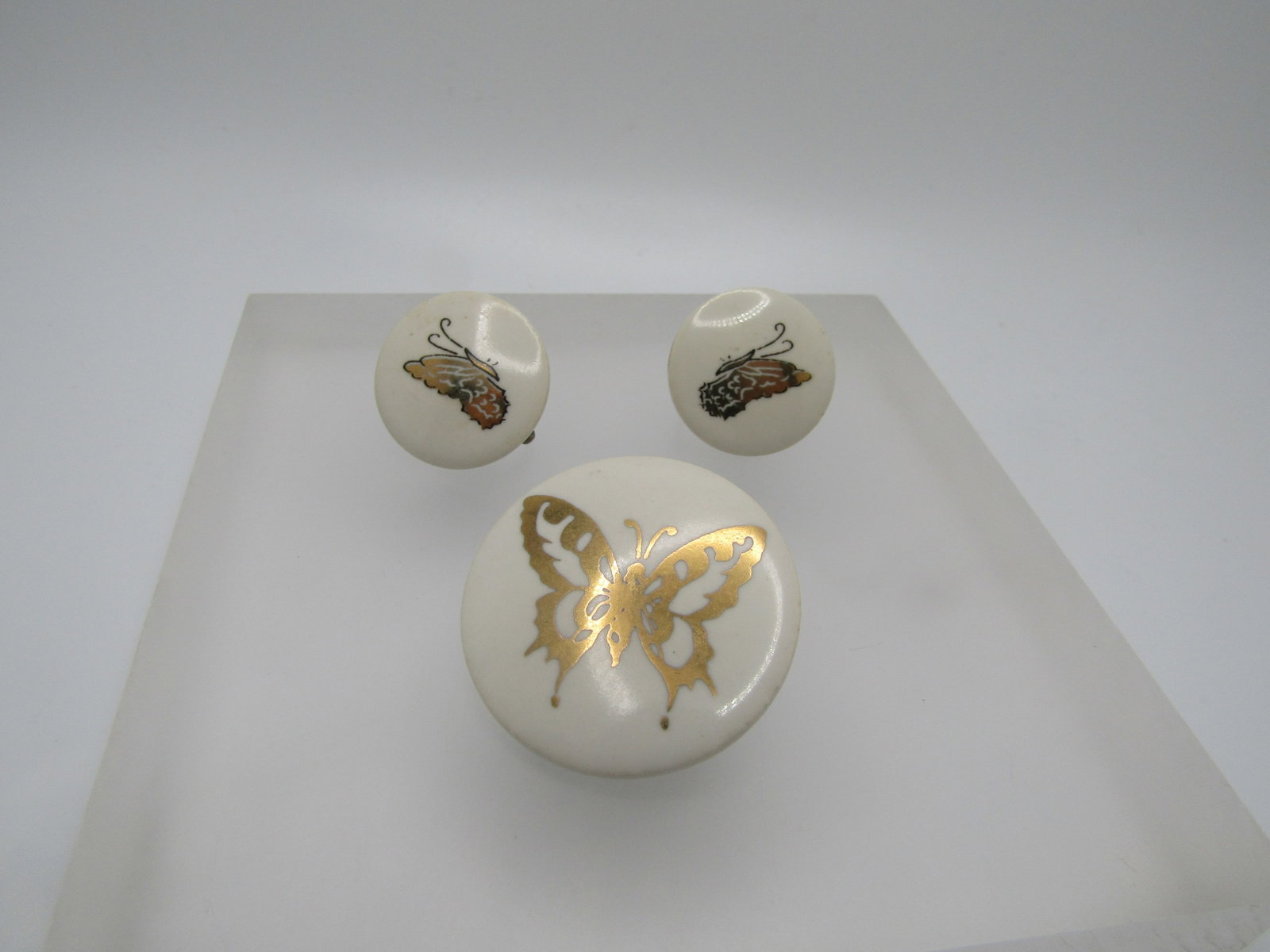 Vintage Ceramic Gold Butterfly Brooch & Earrings, Screwback, 1960's-1970's: Vintage Ceramic Gold Butterfly Brooch & Earrings, Screwback, 1960's-1970's. Glazed white round discs with a gold leaf decal butterfly on the brooch - open wings and appx. 1.25" across. The hearrings