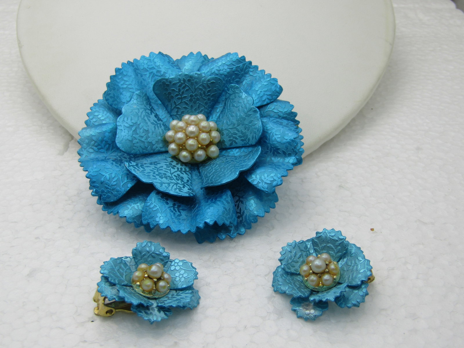 Vintage Aqua Metallic Carnation Brooch Clip Earrings Set, 1960's: Vintage Aqua Metallic Carnation Brooch Clip Earrings Set, 1960's. Large layered brooch with a metallic aqua carnation blossom with spressed blossoms and leaves into the m etal in a satiny background a