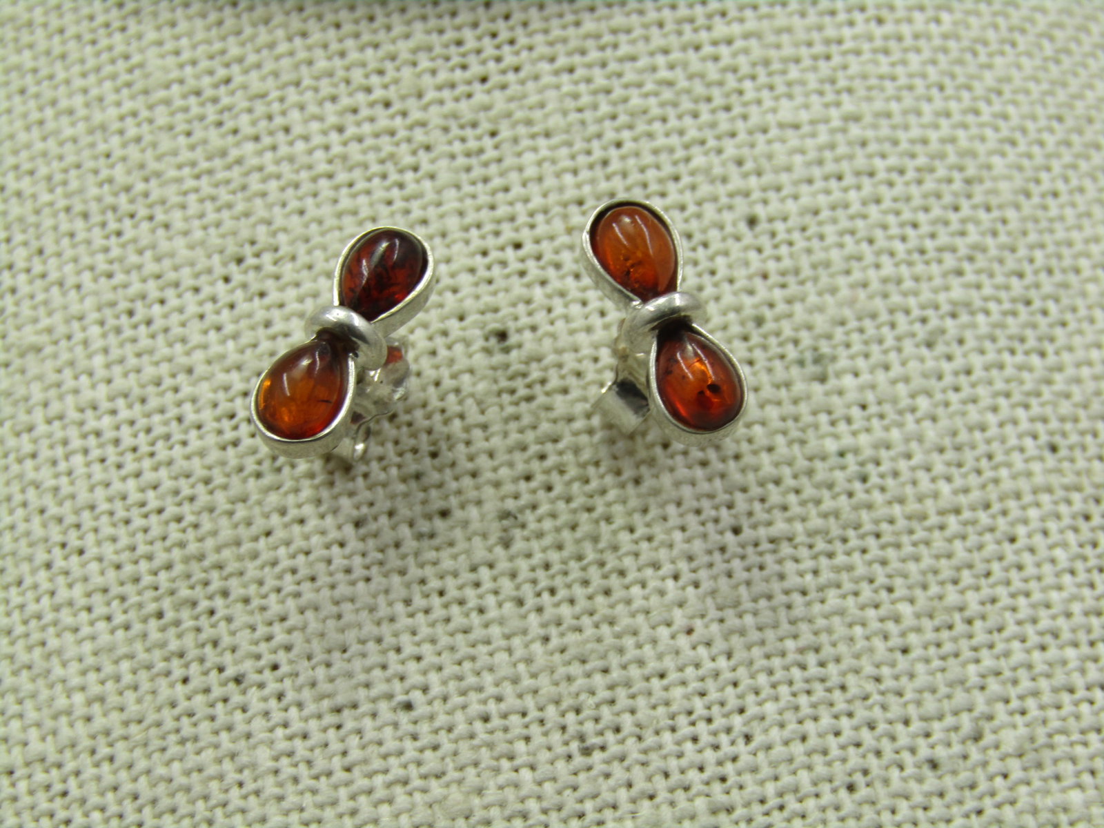 Sterling Silver Amber Pierced Earrings, Figure 8: Sterling Silver Amber Pierced Earrings, Figure 8. These are 1/2" wide and 1/4" tall. They have a pear-shaped stone in each side. They are marked .925 on the clutch and tested Weight of the earrins is