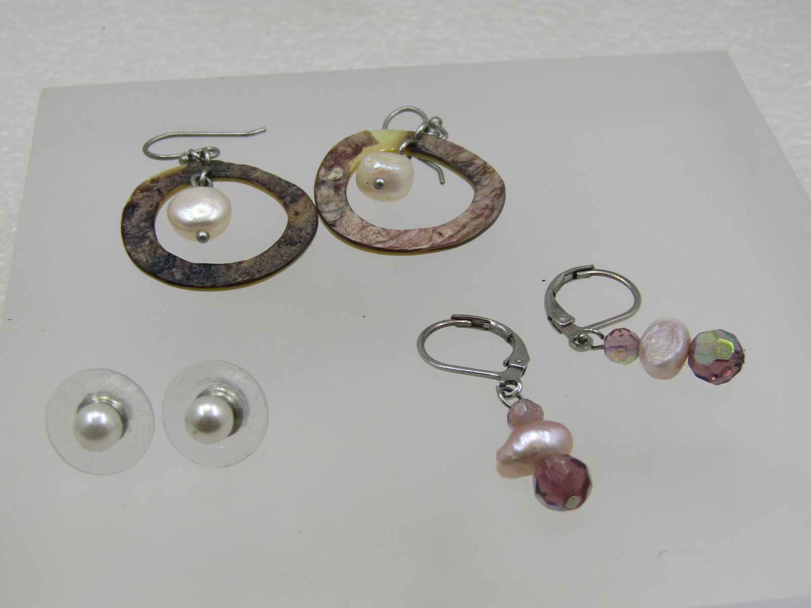 Vintage 3 Pr. Mother-of Pearl/Pearl, Pierced Earrings, 1980's: Vintage 3 Pr. Mother-of Pearl/Pearl, Pierced Earrings, 1980's. Mother of pearl circle hoop earrings with a center dangling pearl They are appx. 1.5" long from the curve in the post and are appx. 1" wi