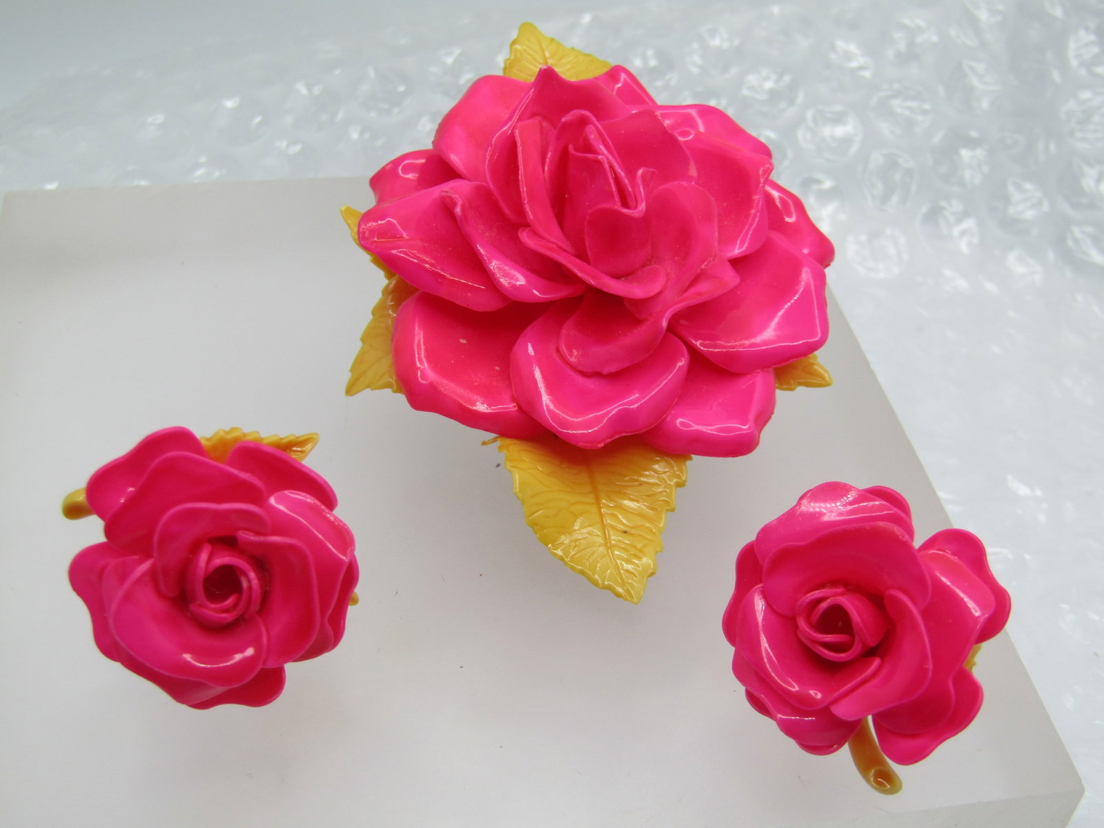 Vintage Plastic Large Rose Brooch & Clip Earrings, 1950's-1960's, 3.25": Vintage Plastic Large Rose Brooch & Clip Earrings, 1950's-1960's, 3.25" by 2.25". Vibrant pink rose with many tiers of petals and tan curved leaves with nice detail. Matching clip earrings that are ap