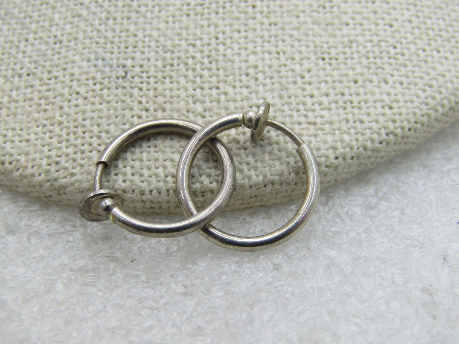 Vintage Silver Tone Hoop Earrings, Pressure Clip-on, 5/8": Vintage Silver Tone Hoop Earrings, Pressure Clip-on, 5/8". 1.5mm tubular. These have a spring-action pressure fit clasp that holds on to the lobe with a wider rim at the back. They look like stering