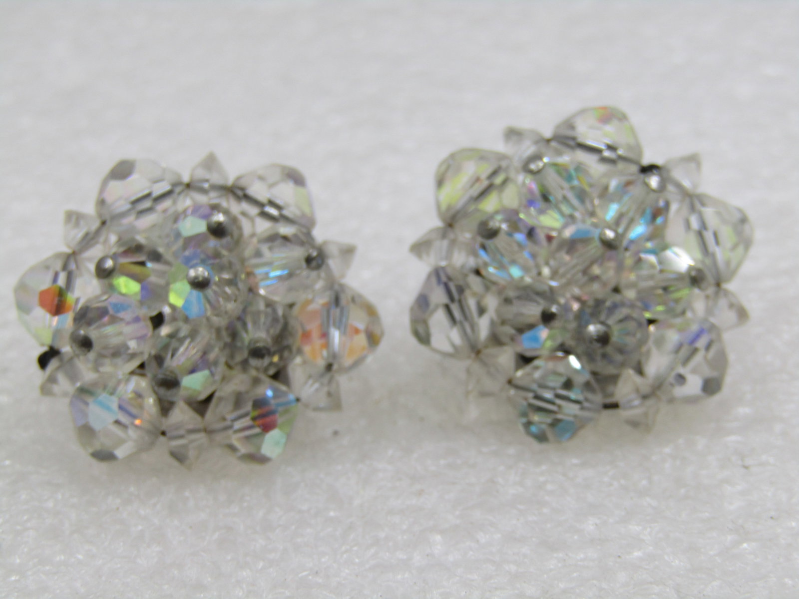 Vintage Crystal Beaded Clip Earrings, Aurora Borealis, 1": Vintage Crystal Beaded Clip Earrings, Aurora Borealis, 1". Round and diamond clear crystal beads with aurora borealis shimmer. Silver tone setting. 1940's-1950's. Very good condition. Not signed by th