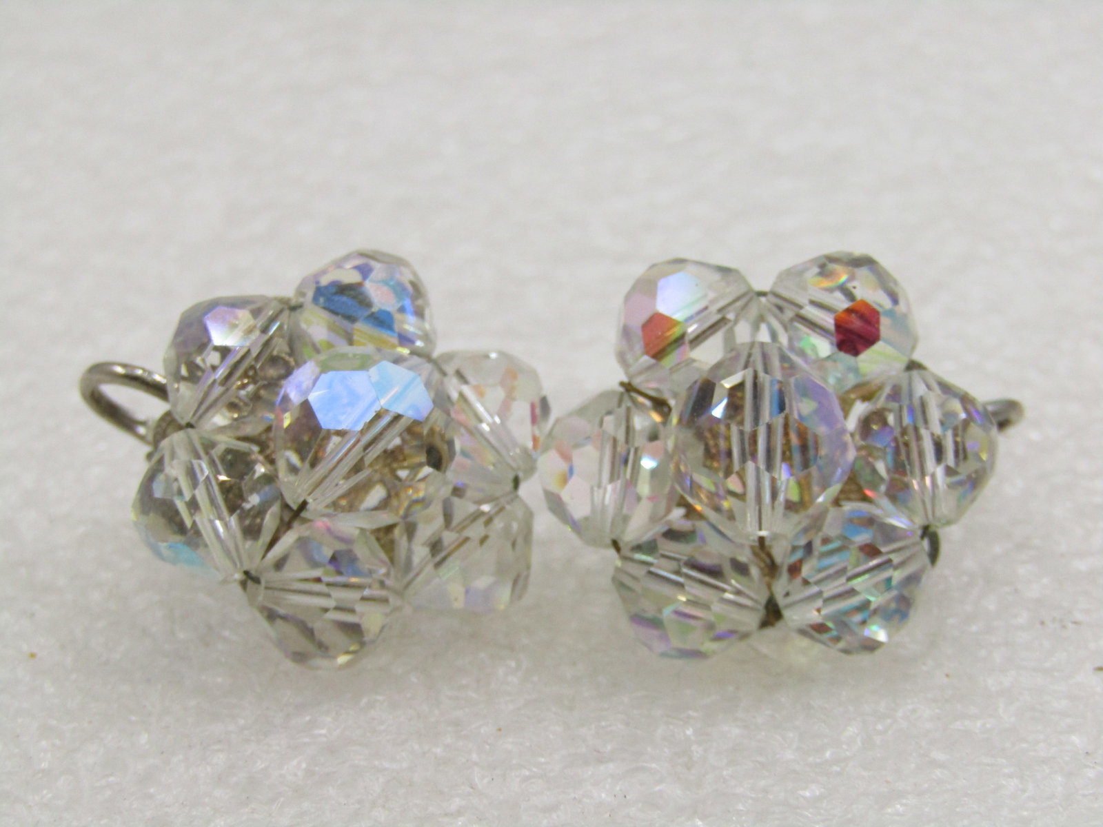 Vintage Aurora Borealis Crystal Clip Earrings, 1940's: Vintage Aurora Borealis Crystal Clip Earrings, 1940's. Silver tone setting with filigree back and appx. just short of 1" round. Larger bead in center, 8mm beads around a 10mm bead. Sturdy clip, not si