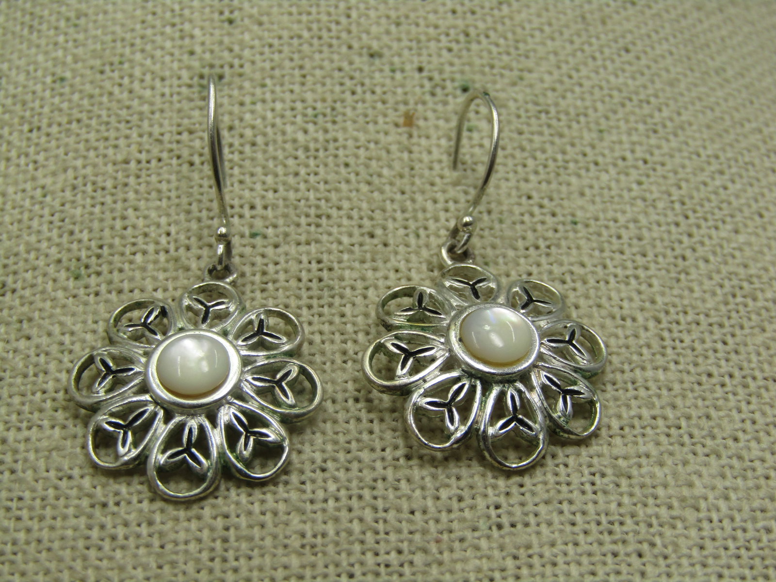 Silver Plated Blossom Earrings, MOP, 1.5", Pierced, Signed CW: Silver Plated Blossom Earrings, MOP, Pierced 1.5" from curve in hook post and the blossoms are appx. .75" wide and slightly domed with open work petals and a center domed mother-of-pearl cabochon. Pie