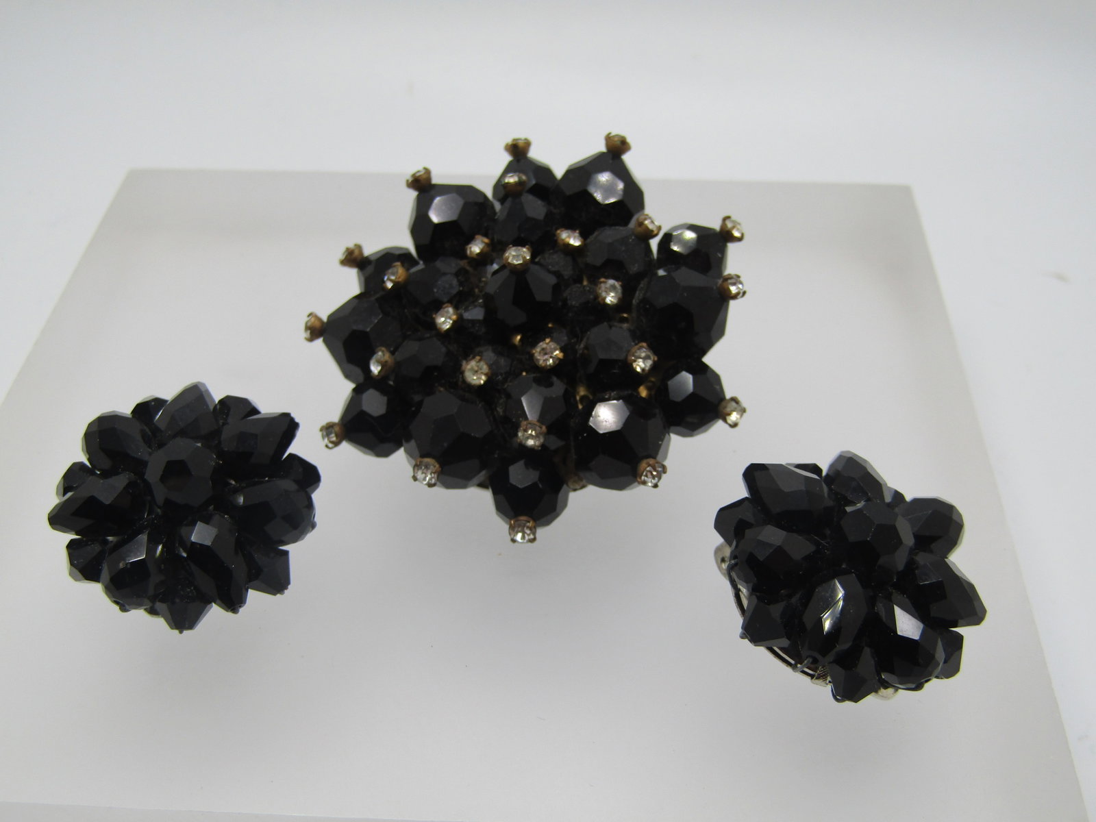 Vintage Black & Clear Faceted Beaded Brooch & Clip Earrings Set, 1950's: Vintage Black & Clear Faceted Beaded Brooch & Clip Earrings Set, 1950's. The brooch has appx 7mm and 9mm faceted round beads with a clear rhinestone on the tip of each bead. The brooch is mounted by w