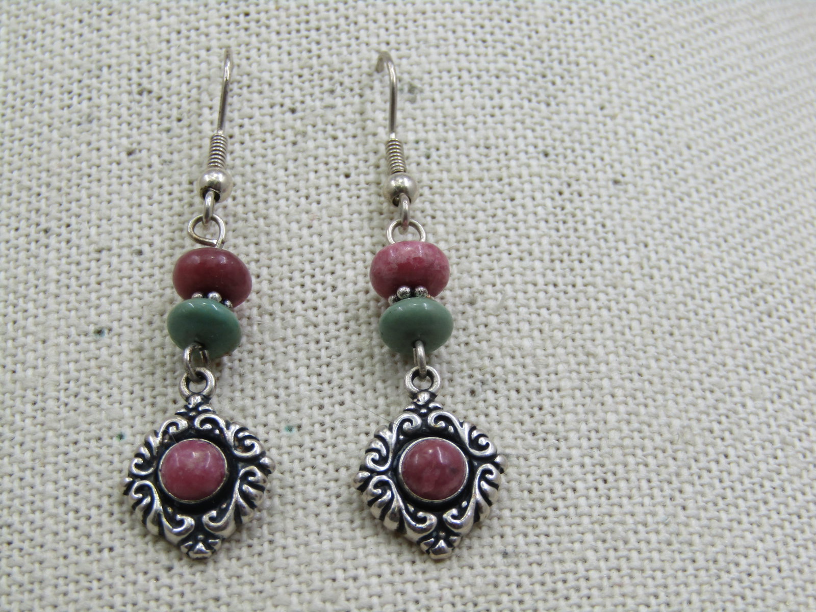 Vintage Sterling Southwestern Drop Rhodocroisite Turquoise Earrings: Vintage Sterling Southwestern Drop Rhodocroisite Turquoise Earrings. 1.75" long from the curve in the hook post with a 6mm rhodocroisite and a 4.5mm turquoise bead and dangling from that is a repousse