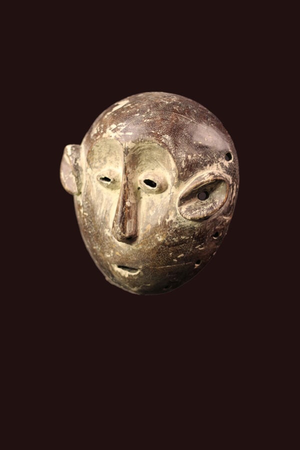 Mask – Wood – Lega – Congo: Lega Mask from Zaire / DR Congo. Wood with multi-layered patina. Remains of offerings, mica powder, kaolin. Condition: good with a beautiful aged patina due to tribal use. Covered in Pembe, white clay