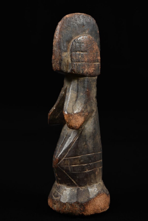 Fertility Doll – Wood – Mossi – Burkina Faso: A very traditional styled Mossi Biga fertility doll, The doll displays the characteristics of an adult woman, with suggestions of facial features and elaborate hairstyles, and usually with mature fema