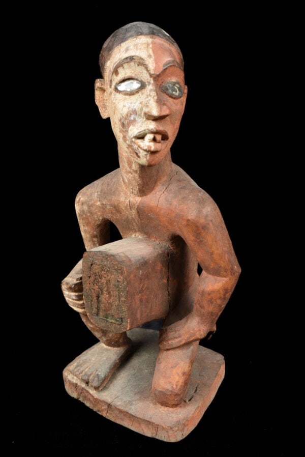 Figure – Wood, Glass – Bakongo – Congo: Stylistic Bakongo Vili ancestor figure from Congo. Powerful appearance with with a great aged patina with traces of tribal use. Figure is painted half white half red. Provenance: former private