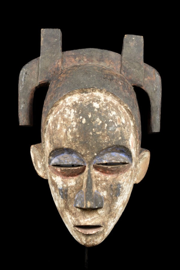 Mask – Wood – Suku – Congo: Worn during male initiation ceremonies, masks like these represented all departed ancestors. Mourning songs were sung during the ritual; the vertical lines on the face are tears. Neighbors of the