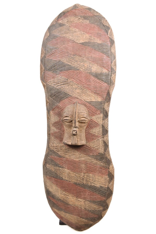 Shield – Wood – Songye – DR Congo: Large wooden shield from the Songye tribe of DR Congo, total length 97 cm. This traditional Songye shield was not only used as a defensive weapon, but also used as decorative and ritual mask and has