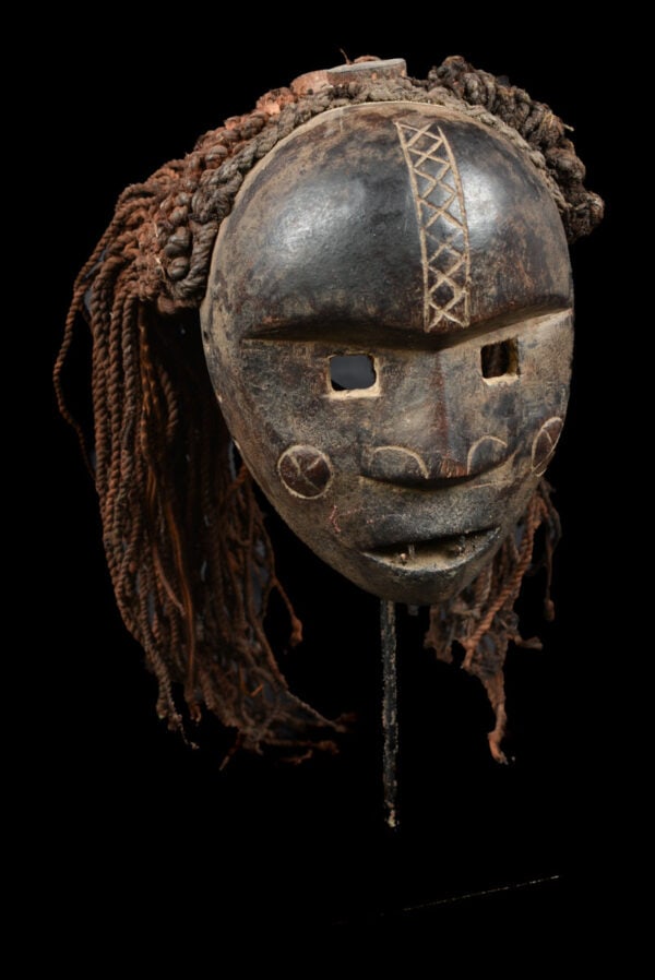Mask – Wood, Rope – Lwena – Angola: Beautifull aged Lwena mask from Angola. As with the neighboring Chokwe people, Lwena masks representing ideal young female beauty, Mwano Pwo, were danced with male counterparts, Chihongo, during initi