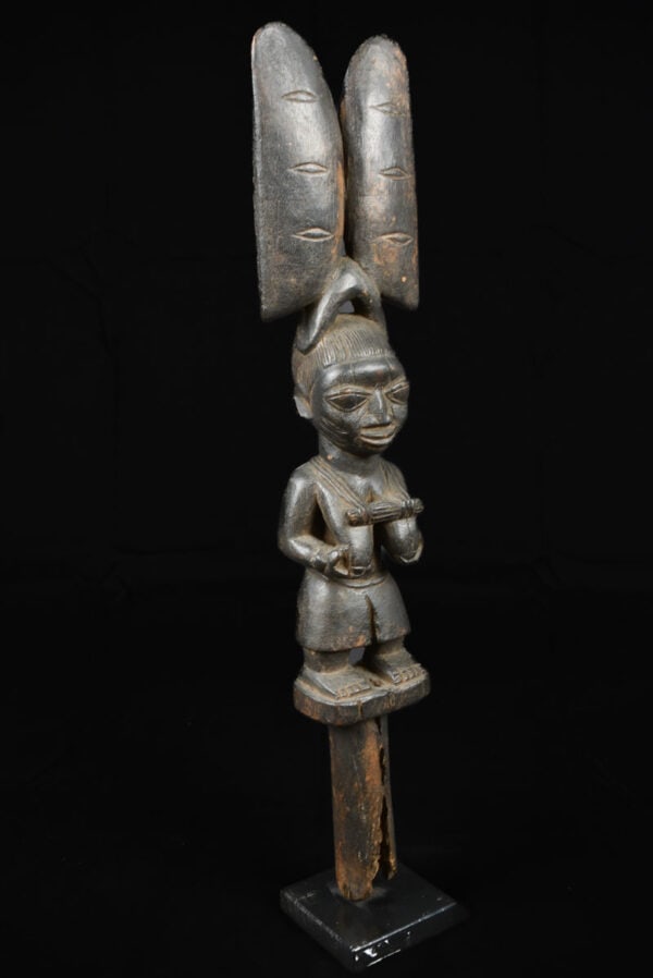Sango Figure – Wood – Yoruba – Nigeria: Stylistic Sango figure from the Yoruba tribe of Nigeria. The name Sango allegedly belonged to the fourth Yoruba king who was deified and became associated with thunder, symbolized by a double-axe