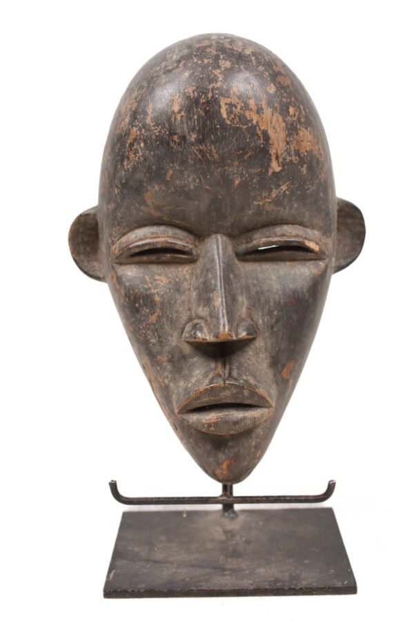 Mask – Wood – Dan – Ivory Coast: Dan mask in a very expressive design. The Dan style is quite evident, with slith eyes and large bulging mouth Good condition with a beautiful aged patina on the wood. The border between Cote d’I