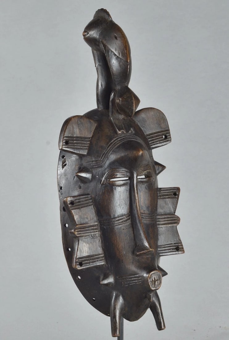 African Art " Ivory Coast" Beautiful Senufo wooden bird mask: Ivory Coast Beautiful Senufo decorative wooden bird mask Dimension: About 12 1/2 inches high Condition: medium Sold without the stand Reserve: $225.00 Shipping: Domestic: Flat-rate of $50.00 to