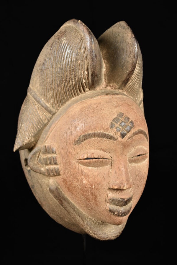 Initiation mask – Wood – Punu – Gabon: Wooden initiation mask from the PUNU tribe, Gabon. PUNU masks are thought to represent ancestors` faces. They are worn during funerals and by a Moukouji initiate who stands on stilts. This masks has a