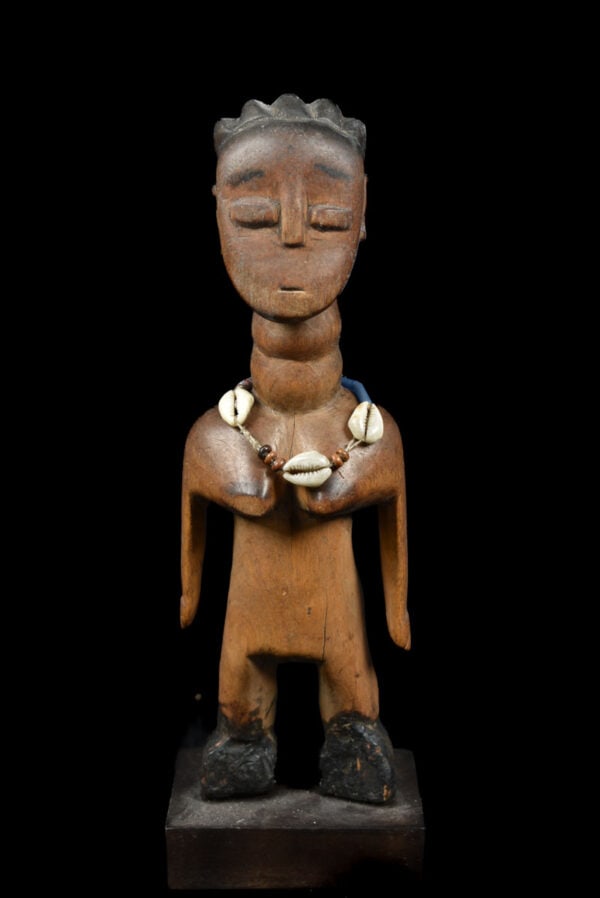 Venavi figure – Wood – Ewe – Togo: A fine venavi figure made out of wood. This miniature is used as a doll among the Ewe people. The Ewe people of Ghana celebrate the birth of twins as a good omen. Twins known as Venavi, lead a life