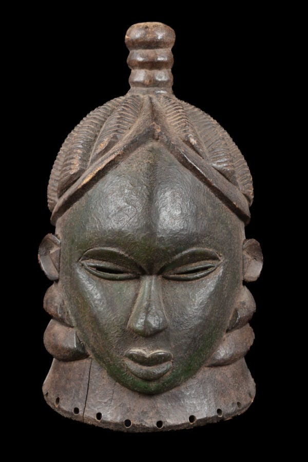 Helmet Mask – Wood – Mende – Sierra Leone: A beautiful helmet mask from the Mende people living in Liberia and Sierra Leone. As symbol of idealized feminine beauty these masks are exclusively worn by women; they play an important role in the