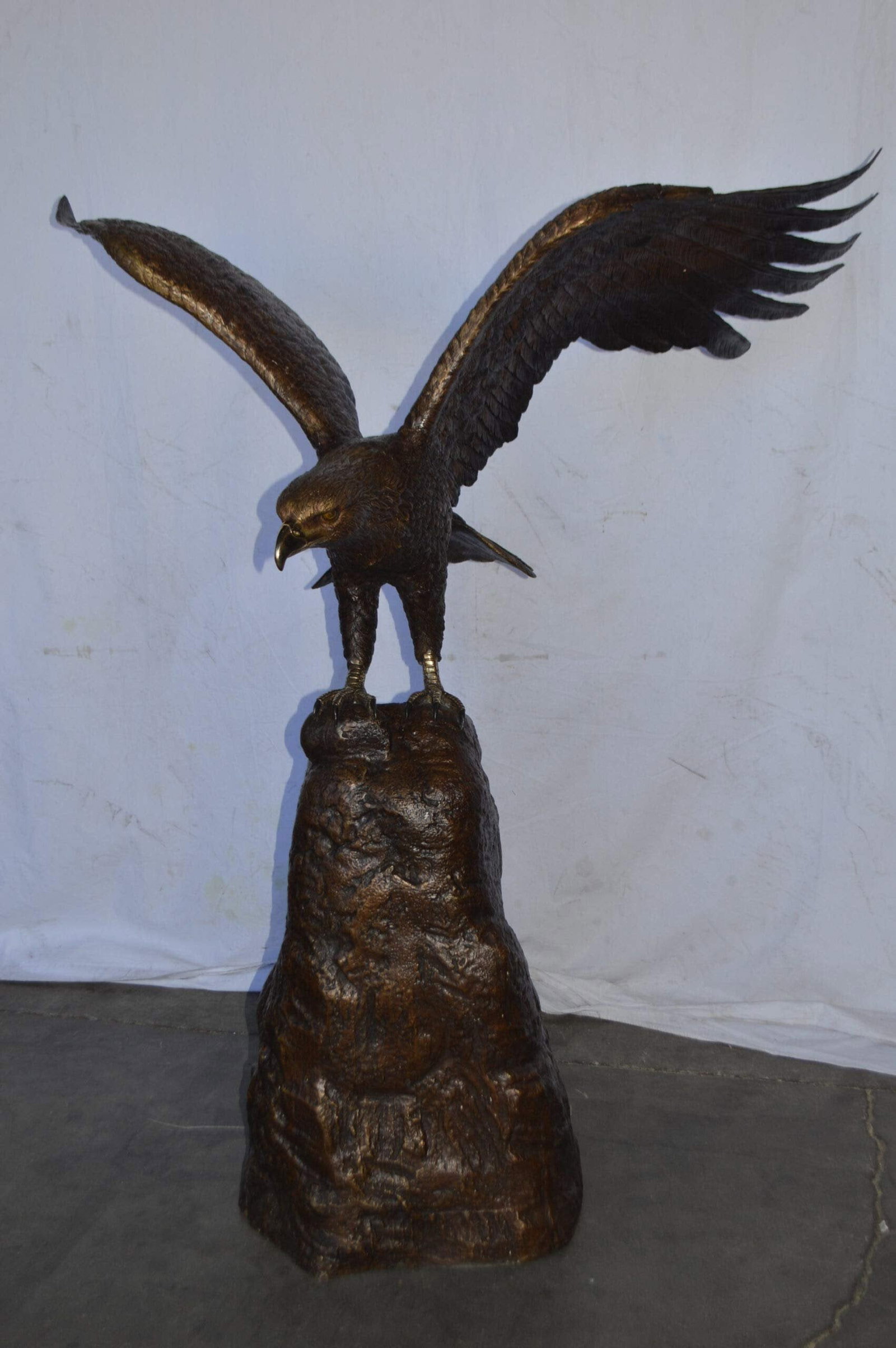Eagle Landing on a Rock Bronze Statue - Size: 51"L x 36"W x 58"H. - 5