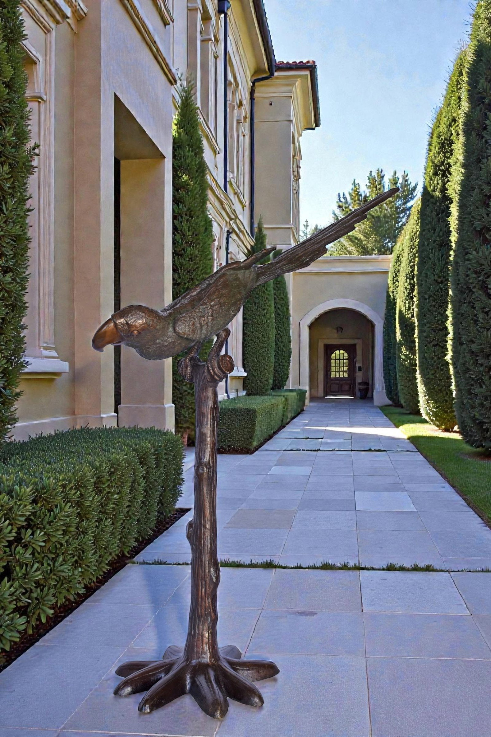 Parrot on a Tree looking Down Bronze Statue - Size: 37"L x 15"W x 47"H. - 2