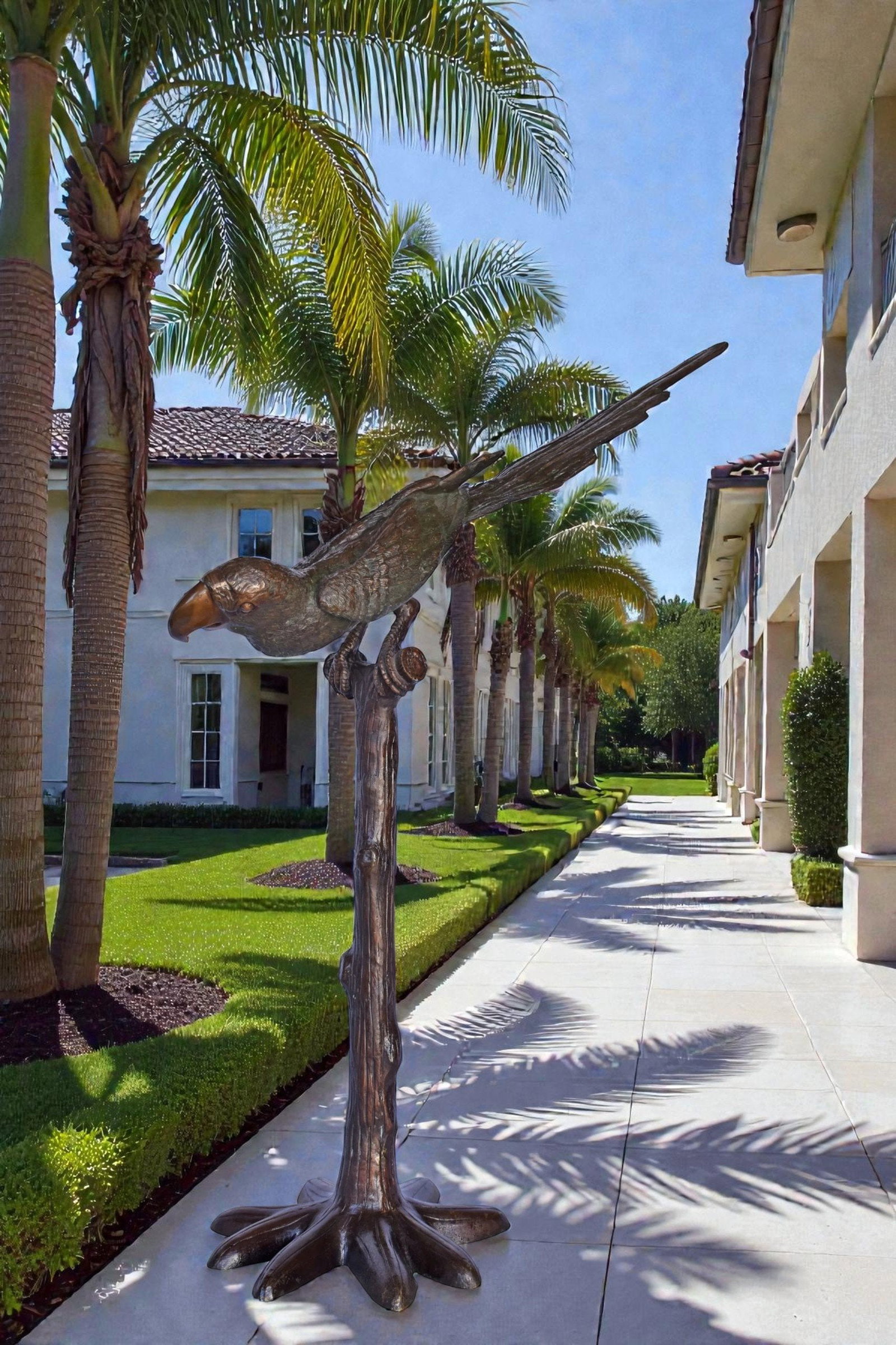 Parrot on a Tree looking Down Bronze Statue - Size: 37"L x 15"W x 47"H. - 3