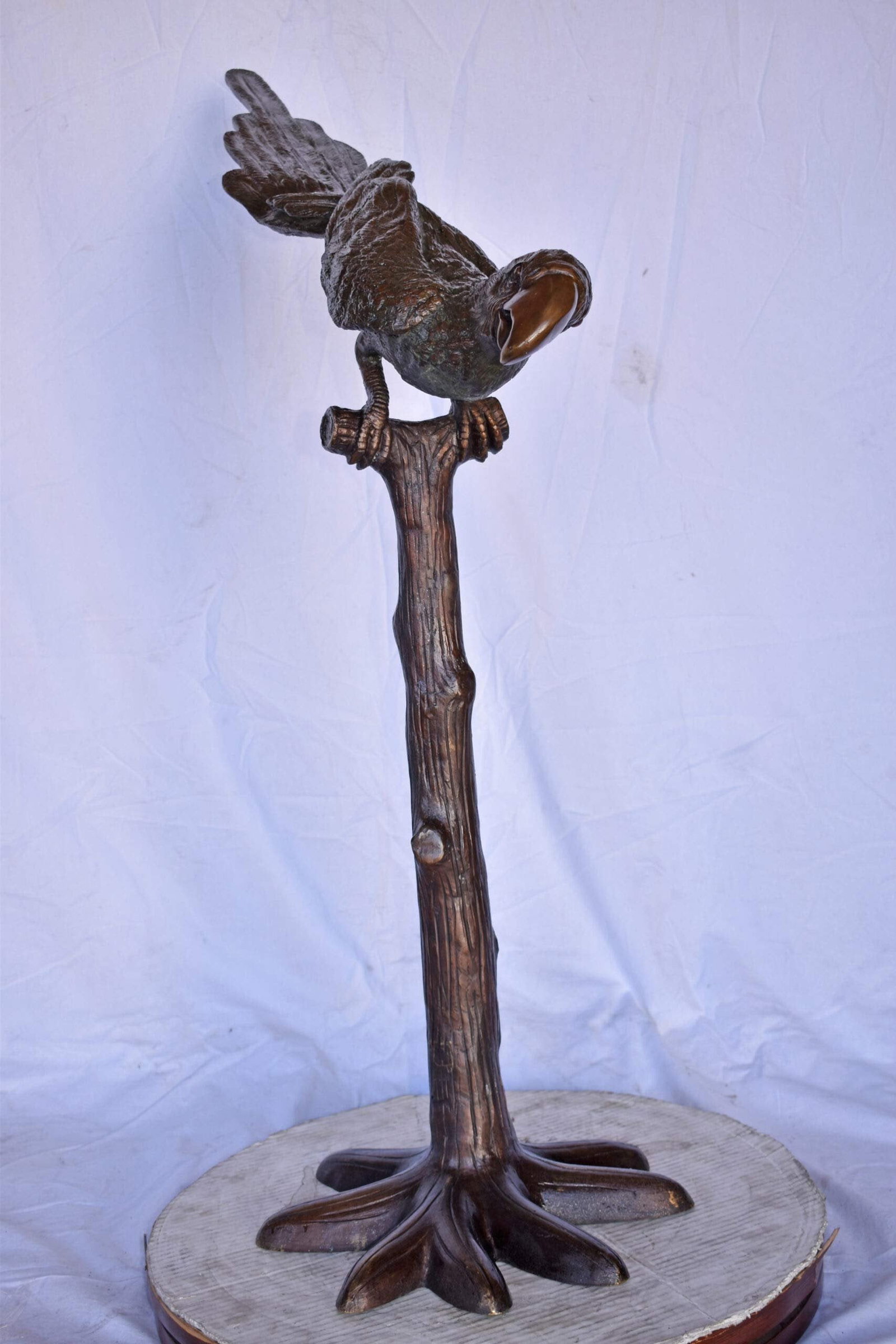 Parrot on a Tree looking Down Bronze Statue - Size: 37"L x 15"W x 47"H. - 6
