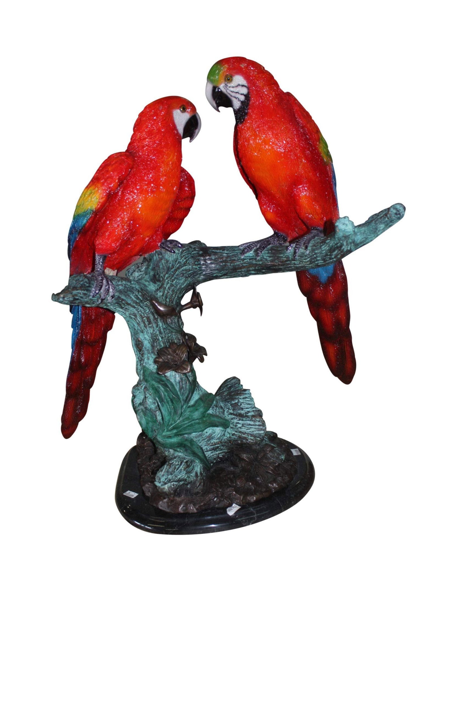 Two Bronze Beautiful Parrots On A Tree: Title:Two Bronze Beautiful Parrots On A Tree Description:A pair of parrots made of bronzed metal perched on a stand with hand-painted finish. This extraordinary sculpture features a realistic tree tru