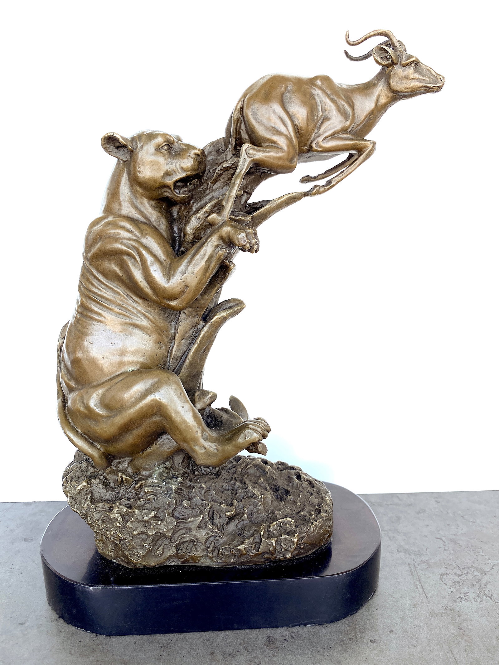 sign. Bronze Lioness hunting an antelope: Title: sign. Bronze Lioness hunting an antelope Maker:Milo Origin: Unkown Date/Period:Unkown Materials:Bronze / Marble Size:Size: 21 x 11 x 33 cm Description:Bronze Lioness hunting an