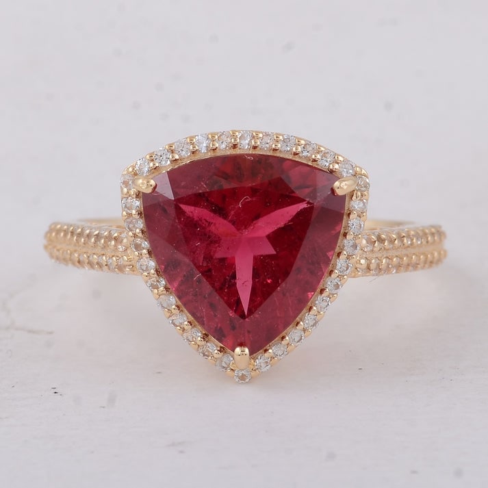 3.62 Ct Trillion Tourmaline 9K Gold Ring: 3.62 Total Carat Tourmaline 9K Gold Ring Specifications: Total Weight 2.71 g Center Gemstone Tourmaline Gemstone Carat Weight 3.28 Carats Gemstone Measurements 10X10 mm Additional Gemstones White Sapp