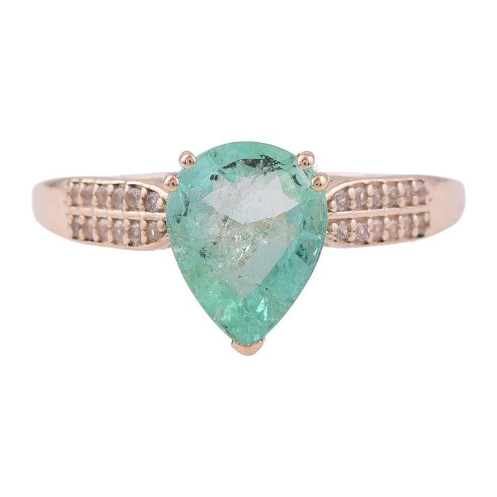 2.02 Ct Pear Emerald 9K Gold Ring: 2.02 Total Carat Emerald 9K Gold Ring Specifications: Total Weight 1.948 g Center Gemstone Emerald Gemstone Carat Weight 1.9 Carats Gemstone Measurements 9X7 mm Additional Gemstones White Sapphire