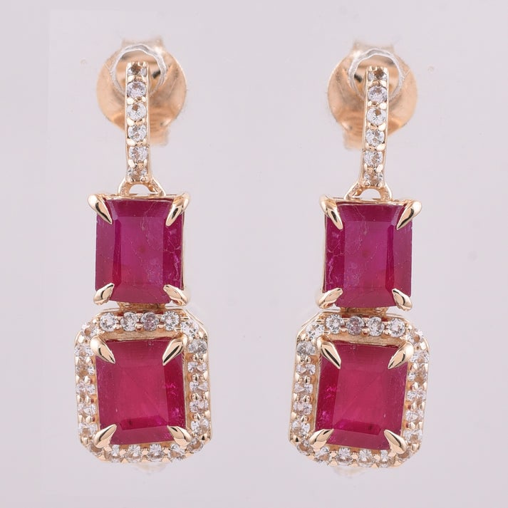 2.73 Ct Octagon Ruby 9K Gold Earrings: 2.73 Total Carat Ruby 9K Gold Earrings Specifications: Total Weight 2.213 g Center Gemstone Ruby Gemstone Carat Weight 2.48 Carats Gemstone Measurements 5X4 mm Additional Gemstones White Sapphire