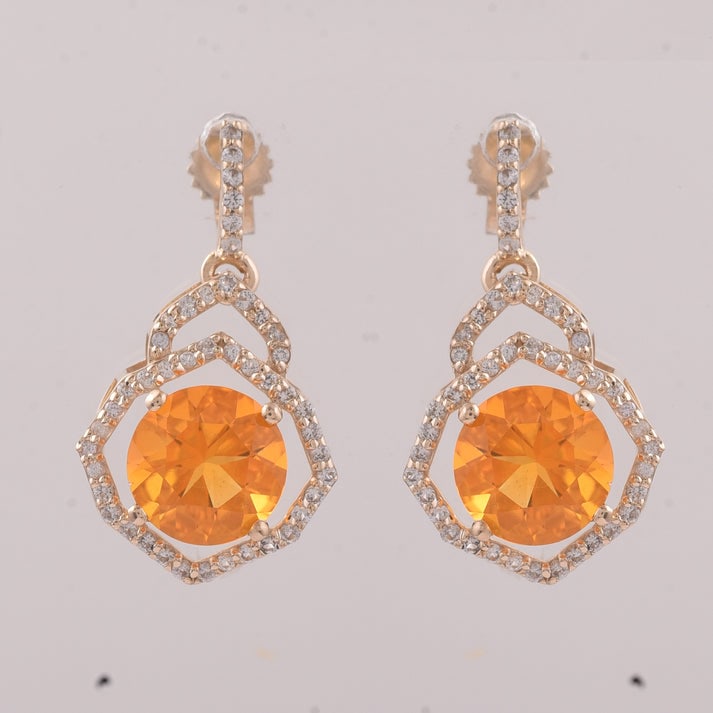 2.10 Ct Round Br.Opal 9K Gold Earrings: 2.10 Total Carat Br.Opal 9K Gold Earrings Specifications: Total Weight 2.121 g Center Gemstone Br.Opal Gemstone Carat Weight 1.73 Carats Gemstone Measurements 7 mm Additional Gemstones White Sapphire 