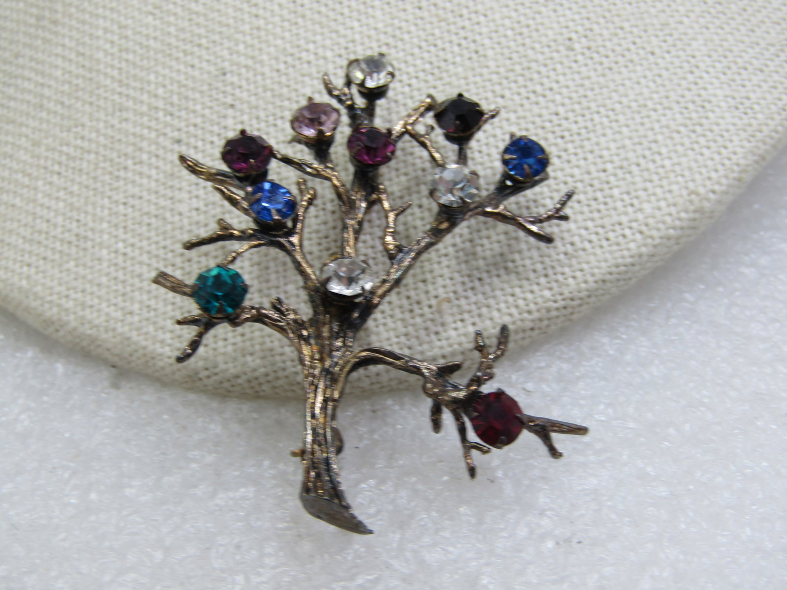 Vintage Sterling Tree/Branch Brooch with Rhinestones, Signed H: Vintage Sterling Tree/Branch Brooch with Rhinestones, Signed H. Marked sterling and weight is appx. 8.16 gr. There are 11 glass faceted stones, appx. 4mm wide in clear, red, blue, aqua, and red. The t