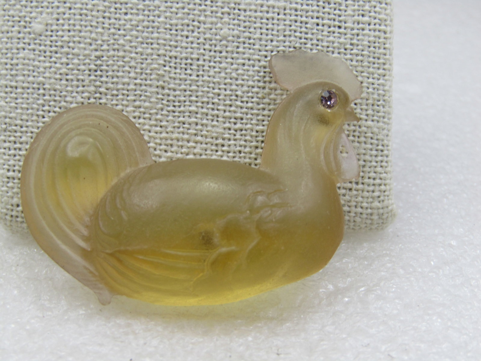 Vintage Pale Yellow Resting Rooster Brooch Rhinestone Eyes, 2": Vintage Pale Yellow Rooster Brooch Rhinestone Eyes, 2" wide and nearly 1.5" tall. The rooster is in a resting position. It is one-side except for the neck to comb - it has a pale lavender rhinestone