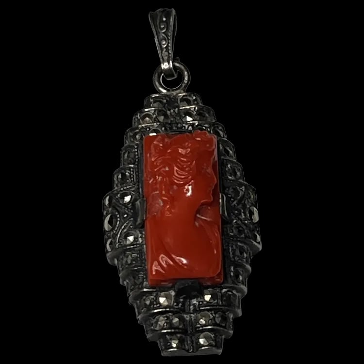 Vintage Carved Coral Cameo and Marcasite Pendant1 x .5 InchesWeight - 3.7 Grams: Vintage Carved Coral Cameo and Marcasite Pendant1 x .5 InchesWeight - 3.7 Grams vintage Coral/Marcasite Measures - 1 x .5 InchesWeight - 3.7 Grams Reserve: $250.00 Shipping: Domestic: Flat-rate of