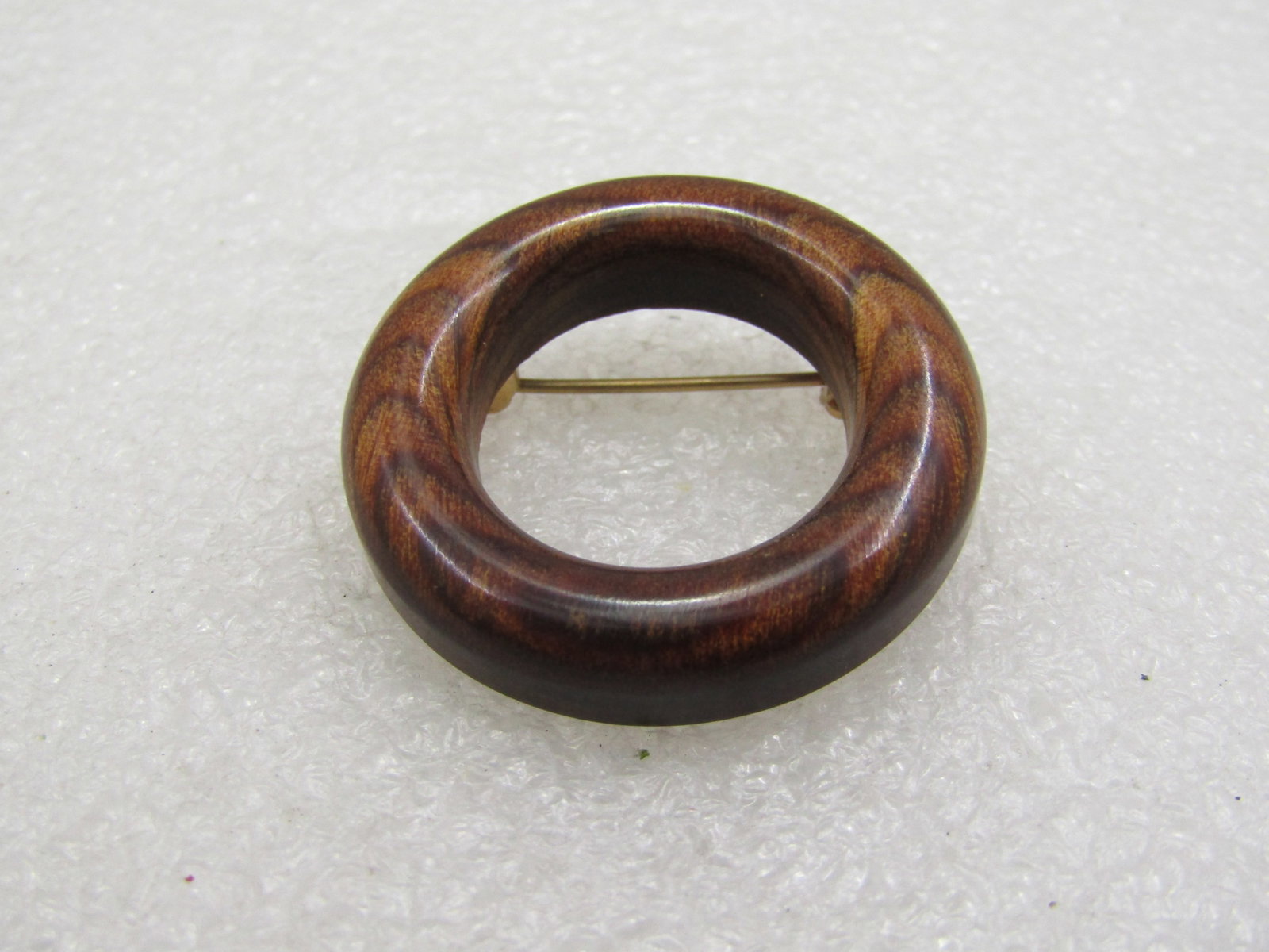 Vintage 1960's Wooden Circle Brooch, 1.25": Vintage 1960's Wooden Circle Brooch, 1.25". Smooth and polished finish. 7mm thick circle of wood. Well made with gold tone pinback that is set into the wood and not glued. Part of the 1960's Mod desig