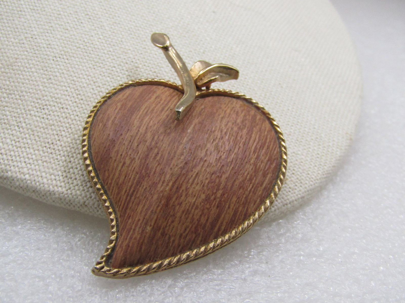 Vintage Wooden Heart Apple/Leaf Brooch, 2.5", 1960's: Vintage Wooden Heart Apple/Leaf Brooch, 2.5", 1960's. The brooch is appx. 1.75" wide. It has a heart-shaped apple domed wooden with ridge gold tone frame and smooth stemp and textured and smooth small