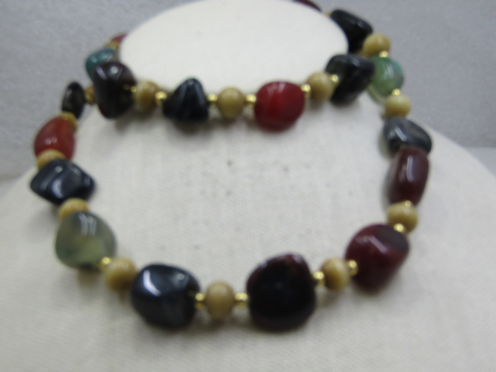 Vintage Mixed Polished Stone Nugget Necklace 26", 1970's-1980's: Vintage Mixed Polished Stone Nugget Necklace 26", 1970's-1980's - a mix of onyx, jadeite, tan cateye/moonstone round beads and a brown carnelian type of nugget. The necklace is 26" long with a barrel