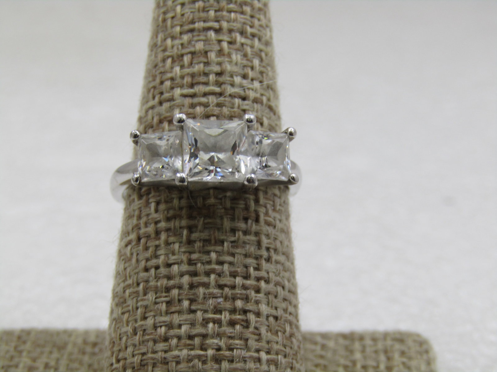 Vintage Sterling CZ Engagement Ring, Signed Diamonique, Sz. 8.25: Vintage Sterling CZ Engagement Ring, Signed Diamonique, Sz. 8.25. Tiered square CZ ring with three pronig-set stones. The main stone is appx. 6mm square and the one on each sides that sit lower is app